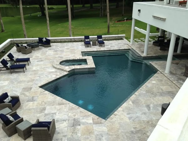 Oyster silver travertine tiles around swimming pool