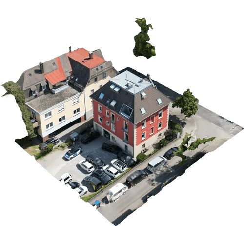 Cut-out 3D model of a red apartment building with adjoining houses, a yard and parking spaces.