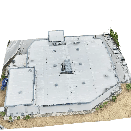 Cut-out 3D model of a large commercial hall with a light flat roof and rooftop units, with a car park alongside.