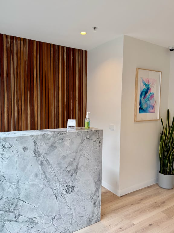 The marble reception desk at Aevum Clinic