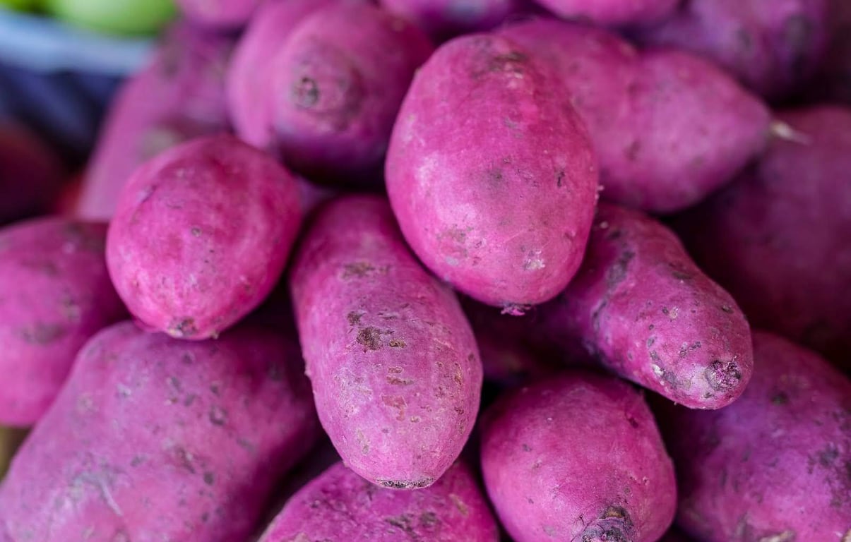 A pile of raw ube yams at a local market in the Philippines