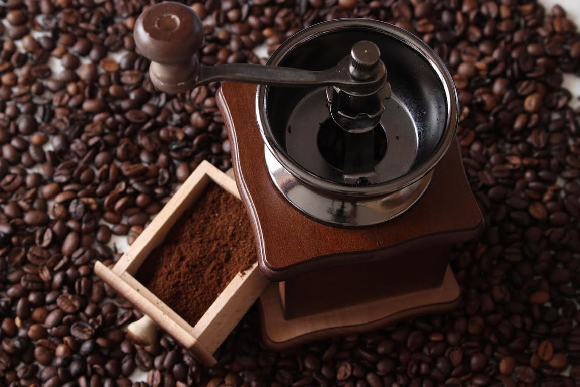 An illustration of flavored coffee beans and grinder