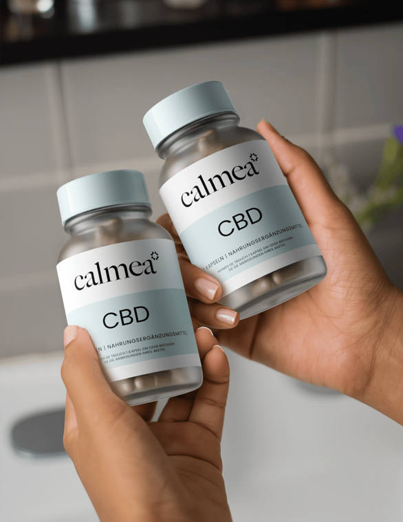 Calmea two bottles held in persons hands