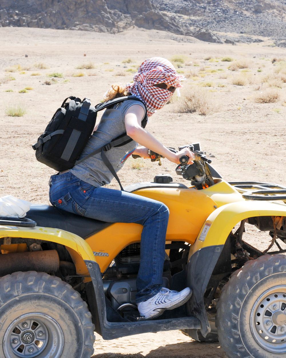 Girl rides atv in the desert