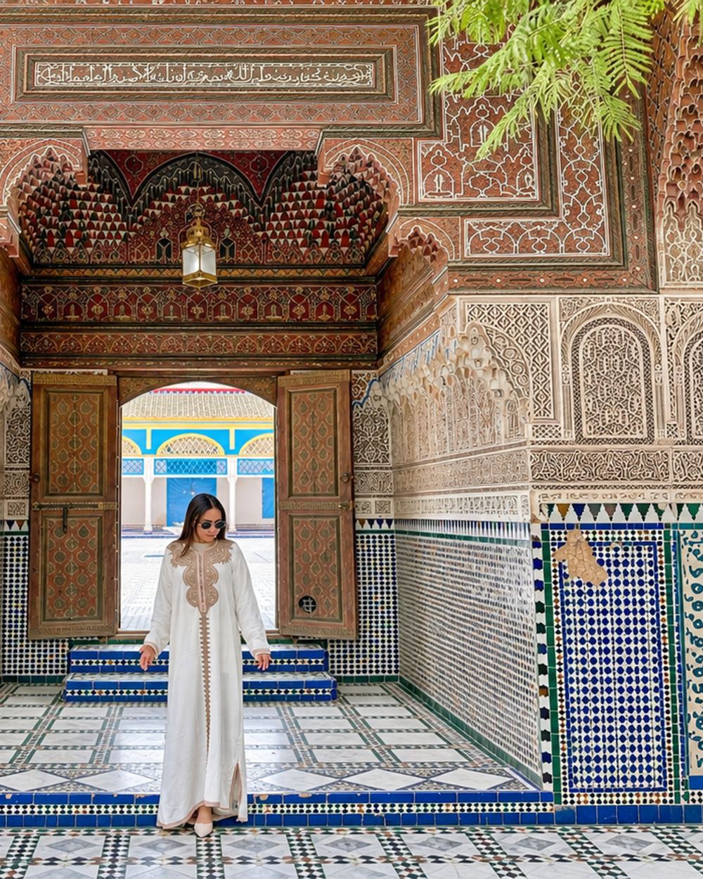 Woman beneath an ornate moroccan doorway
