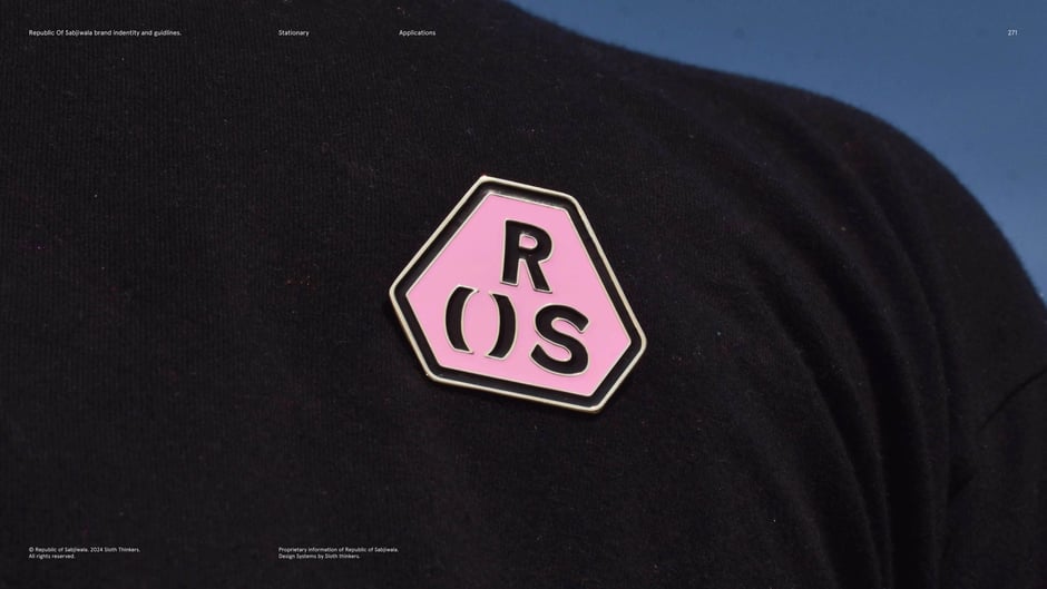 ROS enamel pin on black tee : lifestyle photo