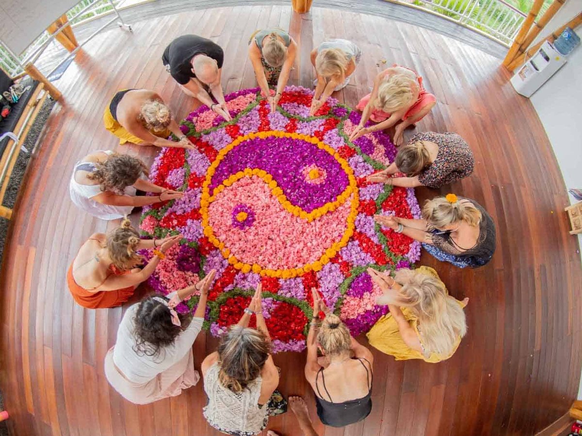 yoga teacher training students around a mandala