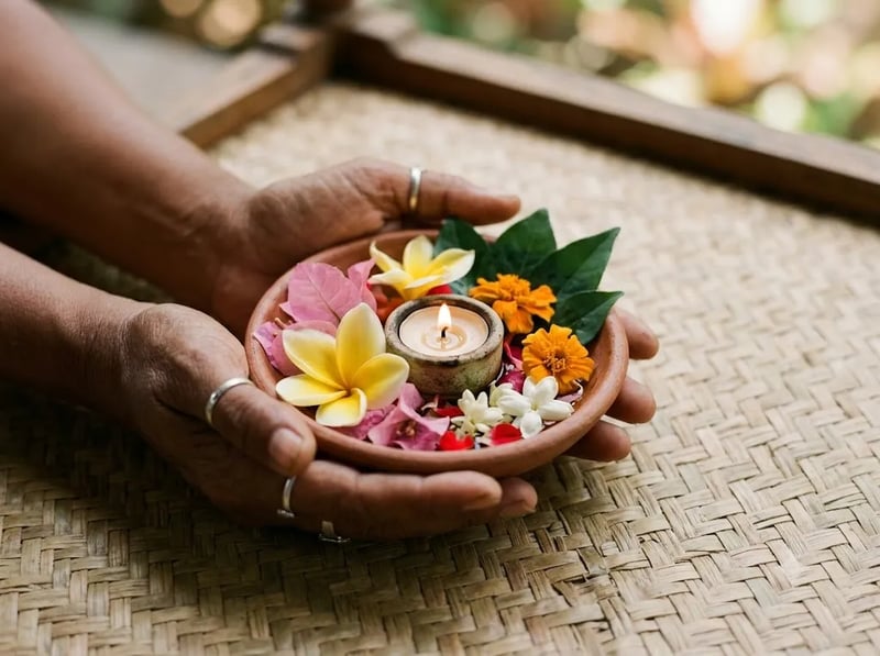 Hands holding a bowl of flower petals beside a candle