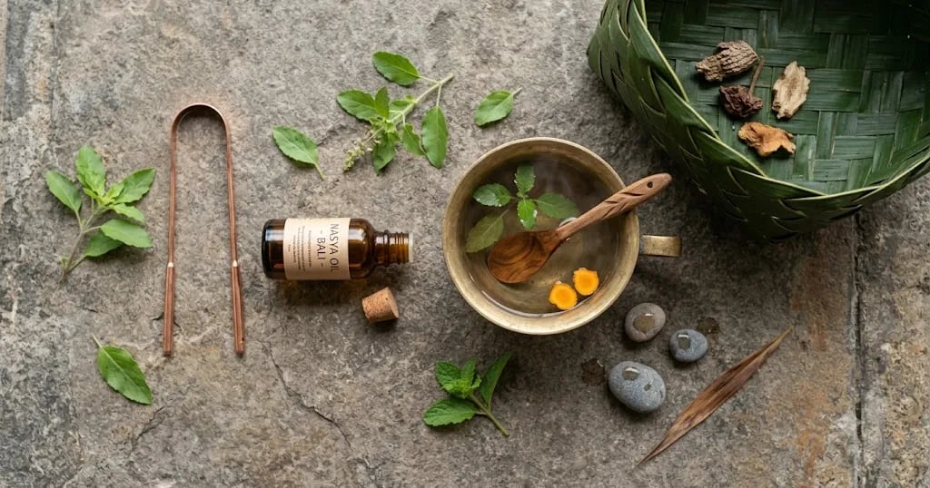 Copper tongue scraper, oil and warm water for a morning Ayurvedic routine