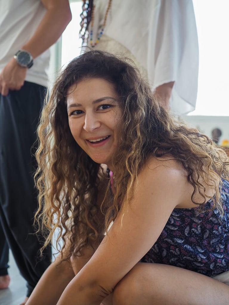 Smiling yoga teacher training student seated at the Loka shala in Bali