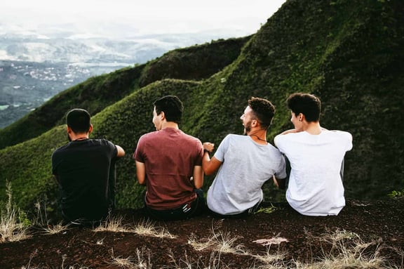 The Power of Empathy four men sitting on ground