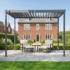 Modern gray pergola over outdoor seating area in backyard garden with lush green lawn and landscaped flower beds, providing stylish outdoor living space.