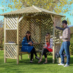 Enjoying a sunny day in a wooden outdoor gazebo with friends, perfect for garden gatherings and outdoor entertainment, featuring elegant garden furniture for relaxation.