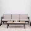 Modern outdoor patio furniture set with a beige cushioned sofa and matching chairs, perfect for garden relaxation and entertaining. Stylish seating arranged with decorative accents against a white background.