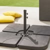 Heavy-duty outdoor umbrella base stand with adjustable height and sturdy weights, ideal for patio furniture and garden setups. Perfect for stabilizing umbrellas on decks and outdoor spaces.
