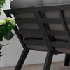 Modern outdoor patio furniture with black metal frames and beige cushions, perfect for garden or backyard relaxation.