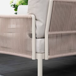 Elegant outdoor lounge sofa with cushioned seating and woven armrest design, perfect for relaxing in a garden or patio setting.