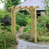 Elegant garden wooden arbor entrance with lush greenery and flowering shrubs, perfect for outdoor home landscaping and garden design, enhancing curb appeal and creating inviting outdoor spaces.