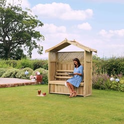 Cozy wooden outdoor bench with a roof in a lush garden setting, perfect for relaxing and enjoying nature. Featuring a classic garden design, ideal for outdoor leisure and patio decor.