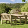 Solid outdoor wooden bench and table set in a lush garden with vibrant trees and plants, perfect for relaxing or outdoor dining. Ideal for garden furniture and outdoor living spaces.
