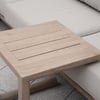 Natural wooden side table next to neutral-colored outdoor sofa, ideal for outdoor living spaces and patio furniture.