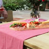 Deluxe charcuterie board featuring cheese, meats, olives, and nuts on a wooden platter, perfect for outdoor dining and garden parties at Empire Home and Garden.