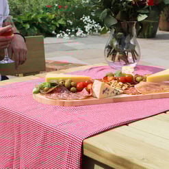 Deluxe charcuterie board featuring cheese, meats, olives, and nuts on a wooden platter, perfect for outdoor dining and garden parties at Empire Home and Garden.