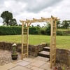 Outdoor garden arbor with wooden lattice and steps, perfect for landscaping and patio decoration, under a cloudy sky.
