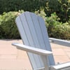 Relaxing outdoor garden chair in a beautifully landscaped backyard with lush plants and blooming flowers. Perfect for outdoor living and garden decor.