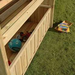 Aerial view of a wooden outdoor storage shed with kids' toys inside, on a grassy lawn with additional toys outside. Perfect for outdoor play storage, garden organization, and backyard kid's activities.