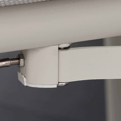 Cable management and adjustable leg support of modern white furniture piece for home or office.