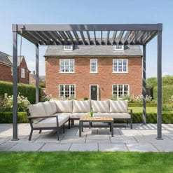 Elegant outdoor seating area with a modern pergola, comfortable sectional sofa, and garden view, perfect for outdoor entertaining and relaxing in a beautifully landscaped backyard.