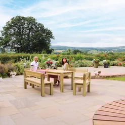 Bright outdoor patio with wooden dining furniture, lush garden backdrop, scenic countryside views, and decorative potted plants for garden enhancement.
