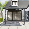 Modern outdoor patio with a sleek pergola, sliding glass doors, and stylish decor, perfect for outdoor living and entertainment.