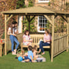 High-quality wooden garden gazebo with a shingle roof, outdoor furniture, and lush landscaping, perfect for family gatherings and outdoor entertaining. Customized garden structures for a backyard retreat.