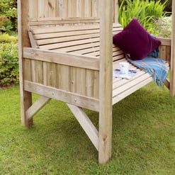 Natural wooden garden swing bench with canopy, perfect for outdoor relaxation, surrounded by lush greenery and colorful flowers.
