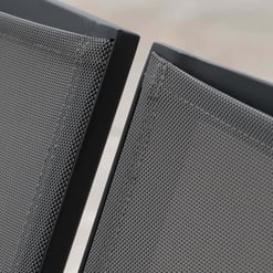 Sleek black outdoor patio chairs with textured mesh upholstery, perfect for modern garden and patio furniture arrangements.