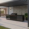 Stainless steel outdoor kitchen with built-in grill, sink, and storage cabinets on a modern patio, perfect for entertaining and outdoor cooking.