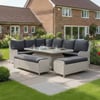 Modern outdoor wicker dining set with a large rectangular table and cushioned benches, perfect for garden entertaining.