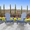 Adorable blue Adirondack chairs in a stylish backyard garden setting featuring lush plants and a wooden fence, perfect for relaxing outdoors.