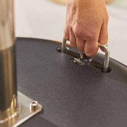 Stainless steel hex key being used to assemble outdoor furniture or garden equipment, emphasizing durable tools for gardening and outdoor living setups.