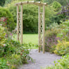 Beautiful garden arbor with a curved top, surrounded by lush greenery and colorful plants, ideal for garden decoration and outdoor living spaces.