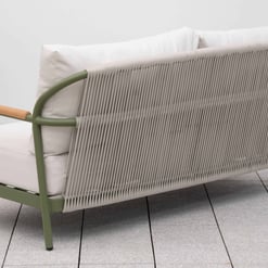 Modern outdoor sofa with woven rope backrest, neutral cushions, and green metal frame, ideal for patio or garden furniture.