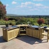 Elegant outdoor garden kitchen with natural wood cabinets and a granite countertop, set against lush scenic landscape and blooming trees, perfect for outdoor entertaining and dining.