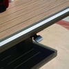 Stylish outdoor wooden patio table with a modern black adjustable fixture, perfect for garden or backyard setting.