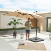 Stylish beige patio umbrella providing shade on a modern outdoor rooftop terrace with minimalist decor and lush greenery.