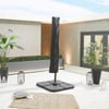 Modern outdoor patio with umbrella, decorative lanterns, lush potted plants, and contemporary design elements, perfect for outdoor living and entertaining.