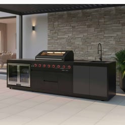 Modern outdoor kitchen with built-in grill, sink, and refrigerator, perfect for backyard entertaining and outdoor living. Designed by Empire Home and Garden for stylish exterior spaces.