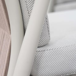 Modern outdoor patio furniture with cushioned seating and neutral fabric, perfect for garden or outdoor living spaces.