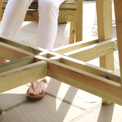 Natural wood outdoor furniture being assembled, showcasing quality craftsmanship and sturdy construction. Perfect for enhancing your garden or patio space with stylish, durable outdoor pieces.